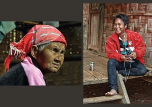 two of thailand's hilltribe people are in this image, an indigenous lahu elder is on the left and a lahu youth is on the right while holding an electronic device and drinking a beer