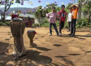 northern thailand hilltribes - jeffrey warner - development- culture change - Ethnic Black Lahu youth at, and not participating in, their village’s annual New Year festival.