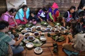 northern thailand hilltribes - jeffrey warner - development - karen family eating together