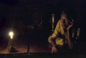 northern thailand hilltribes - jeffrey warner - nam bor noi karen village - old man with his eyes closed while next to a candle